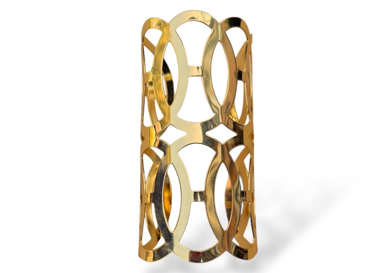 A Golden Metal Long Curved Open Cuff With Two Rows Of Five Interlocking Flat Oval Bands.