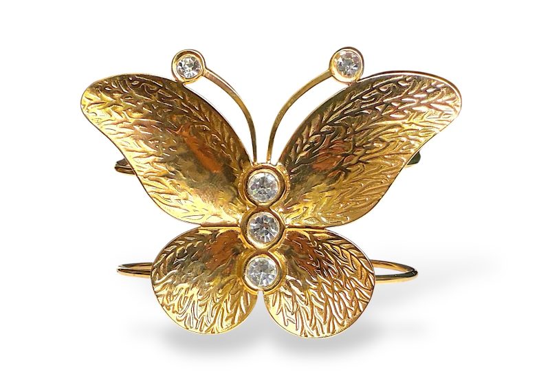 A Golden Metal Open Cuff With A Butterfly Inlaid With Clear Facetted Glass Domed Circular Beads.