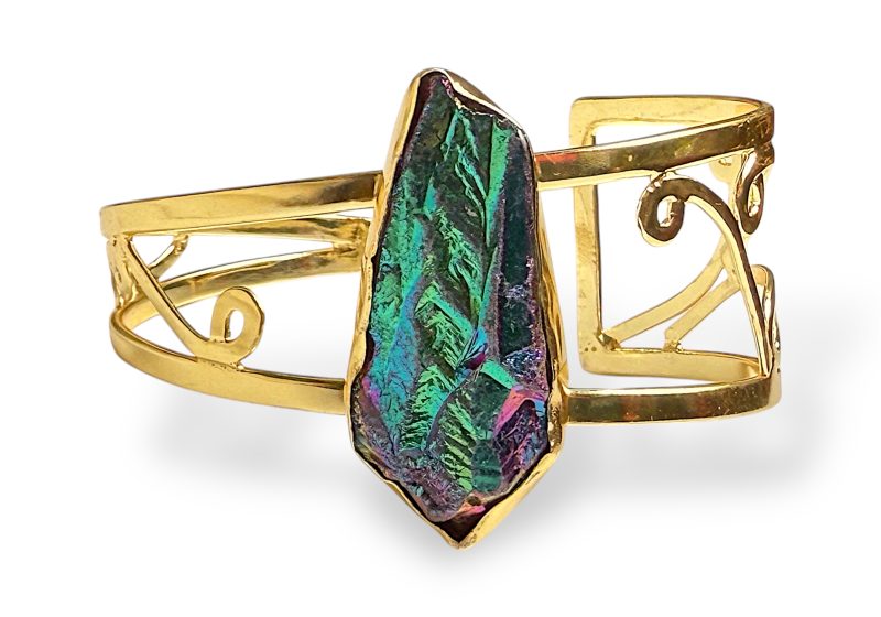 A Gold Plated Filigree Patterned Tapered Open Cuff With A Long Iridescent Blue And Green Electroplated Crystal