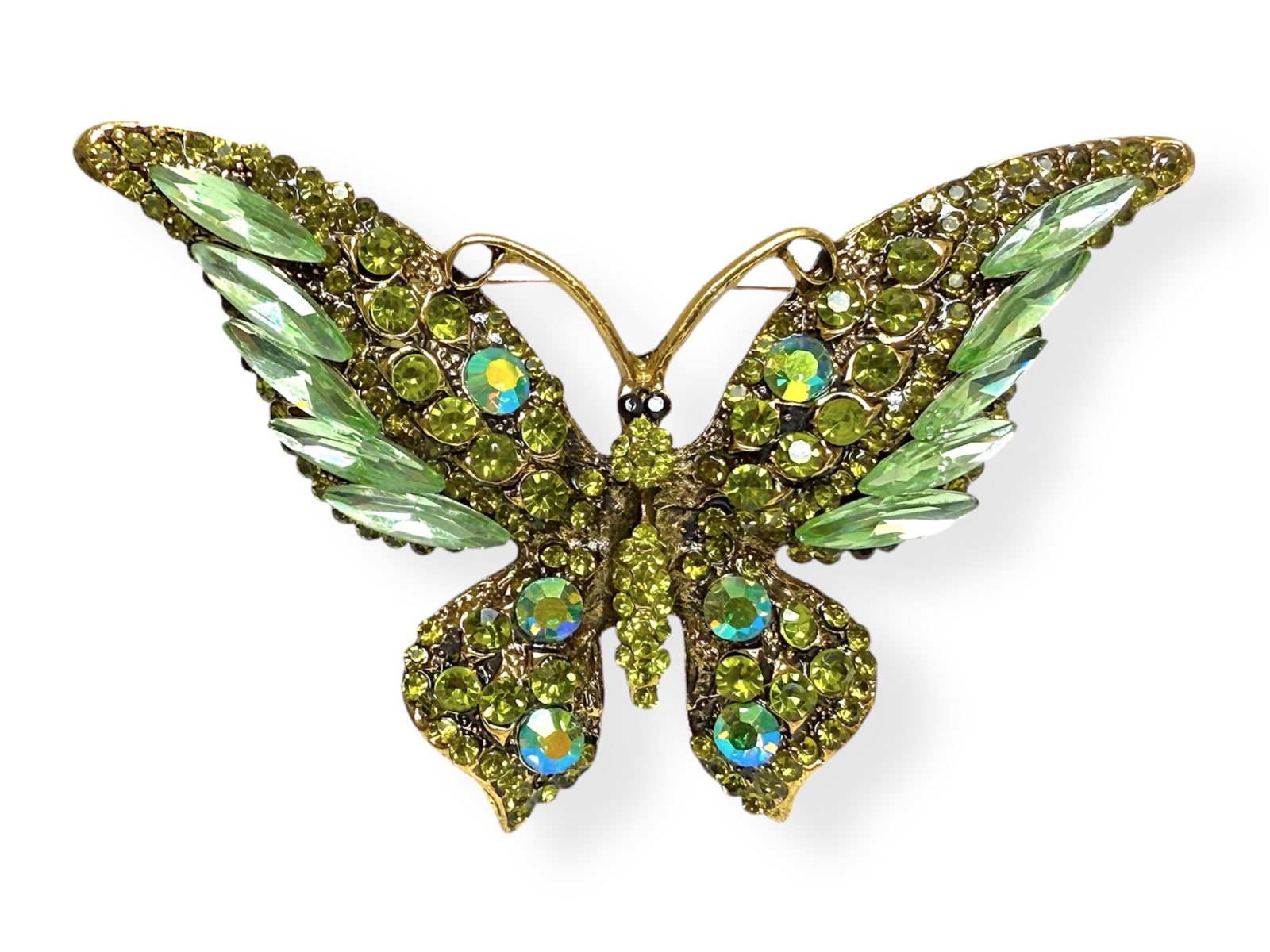 A Golden Metal Butterfly Brooch Inlaid With Light And Dark Green Facetted Glass Mixed Sized Beads.