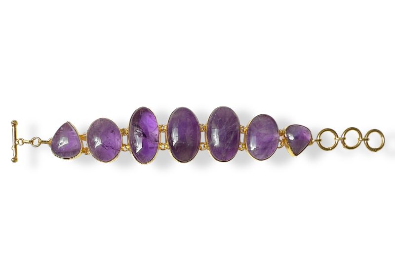 A Gold Plated Bracelet With Oval And Teardrop Shaped Linked Panels, Each Inlaid With An Amethyst Cabochon.