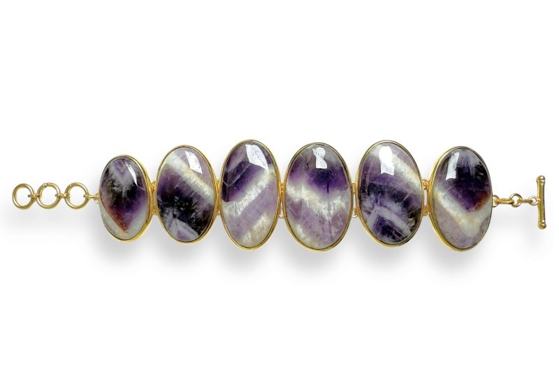 A Gold Plated Bracelet Of Six Large Oval Panels, Each Inlaid With A Banded Amethyst Domed Oval Cabochon.