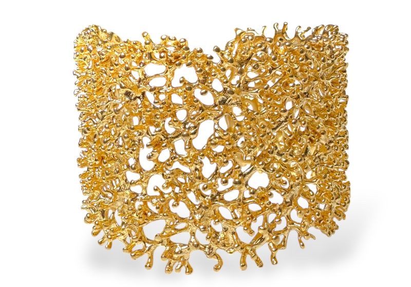 A Golden Metal Wide Band Open Cuff Of Structured Interlocking Bands With Small Round Bead Finials.