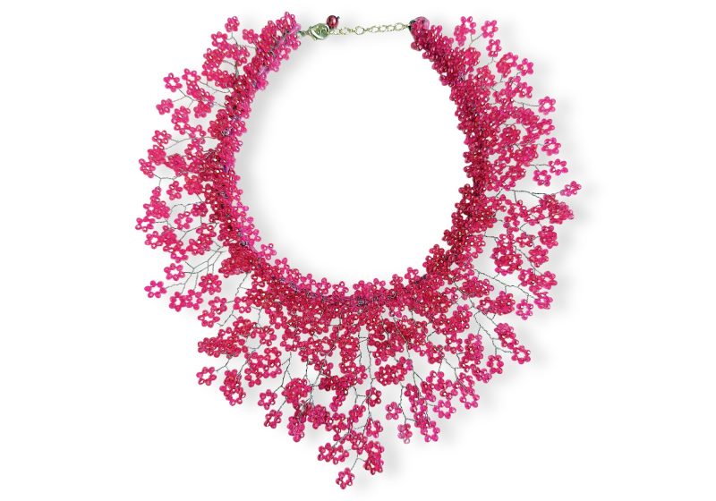 A Floral Patterned Circular Band Necklace With A Fringe Of Small Pink Facetted Glass Round Beads Attached To Silvered Metal Wire Bands.