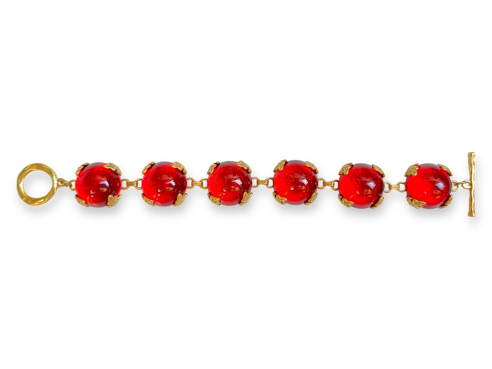 A Golden Metal Bracelet Of Six Linked Circular Panels, Each With A Red Glass Domed Circular Cabochon.