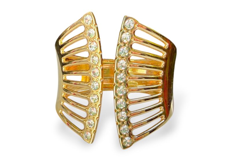 A Golden Metal Wide Tapered Bands Hinged Open Cuff With Two Curved Bands At The Front, Inlaid With Clear Facetted Glass Beads.