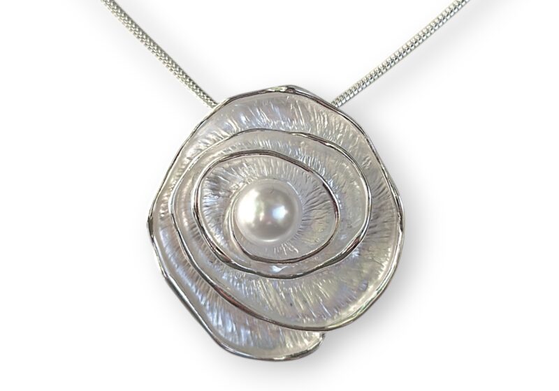 A Silvered Metal Coiled Band Pendant With Silvered Enamelling And A White Glass 'Faux Pearl', On A Silver Plated Chain Necklace.