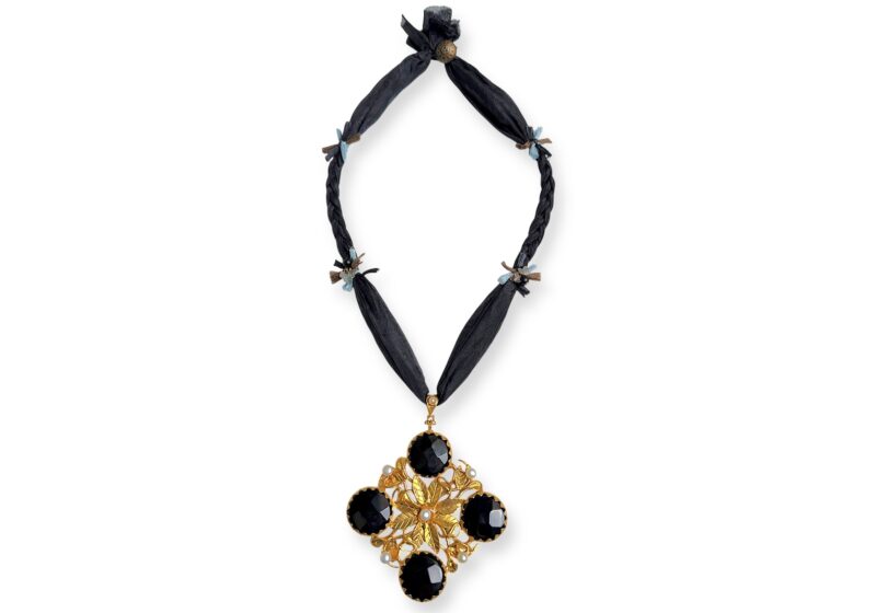 A Black Silk Long Necklace, With A Gold Plated Floral Patterned Pendant, Inlaid With Black Onyx Discs And White Freshwater Pearls.