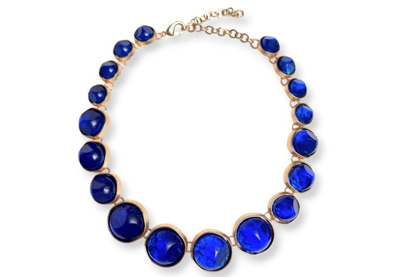 A Golden Metal Chain Necklace With Golden Metal Circular Panels, Each Inlaid With A Blue Glass Domed Circular Cabochon.