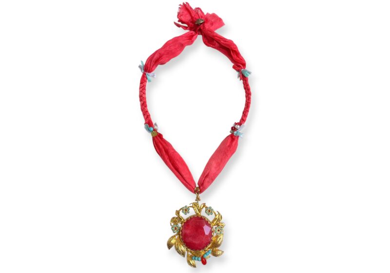 A Gold Plated Floral Pendant Inlaid With A Red Dyed Facetted Agate Disc,Turquoise And Red Glass Round Beads, On A Red Silk Long Necklace.