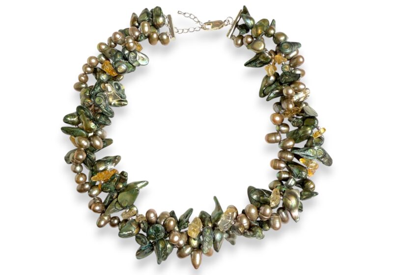 A Three Strand Necklace Of Mixed Shaped And Sized Golden, Green, And Black Dyed Freshwater Pearls And Amber Resin Chips.
