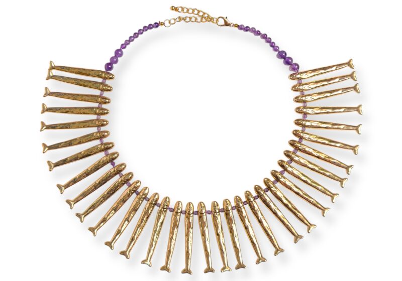 A Necklace Of Thirty-Three Golden Metal Long And Narrow Patterned Fish Drops, And Amethyst Beads And Spacers.