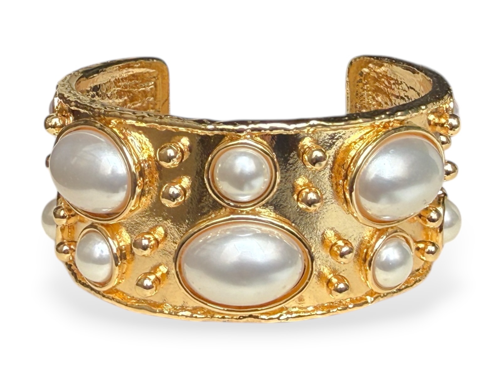 A Golden Metal Open Cuff With Small Studs And Twelve Mixed Sized And Shaped White Glass 'Faux Pearls'.
