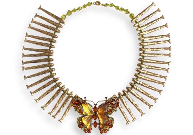 A Golden Metal Necklace Of Long Narrow Fish Drops, Facetted Green Glass Beads And A Large Facetted Glass Inlaid Butterfly Pendant