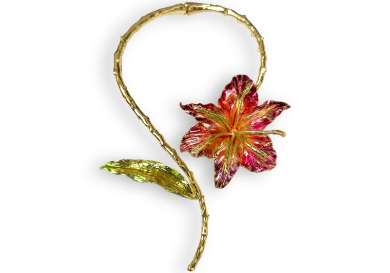 Golden Metal Torque Necklace With An Enamel Painted Lily And Leaf