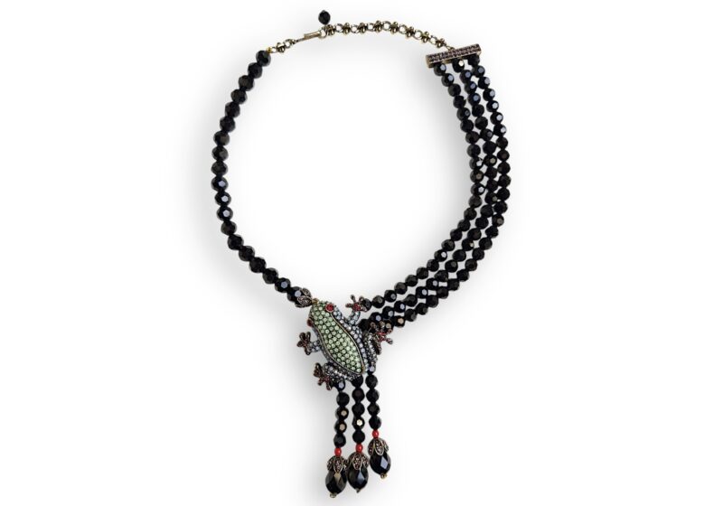 Asymmetrical Necklace Of Black Facetted Glass Beads With Golden Metal Inlaid Frog Pendant With Beaded Tassels