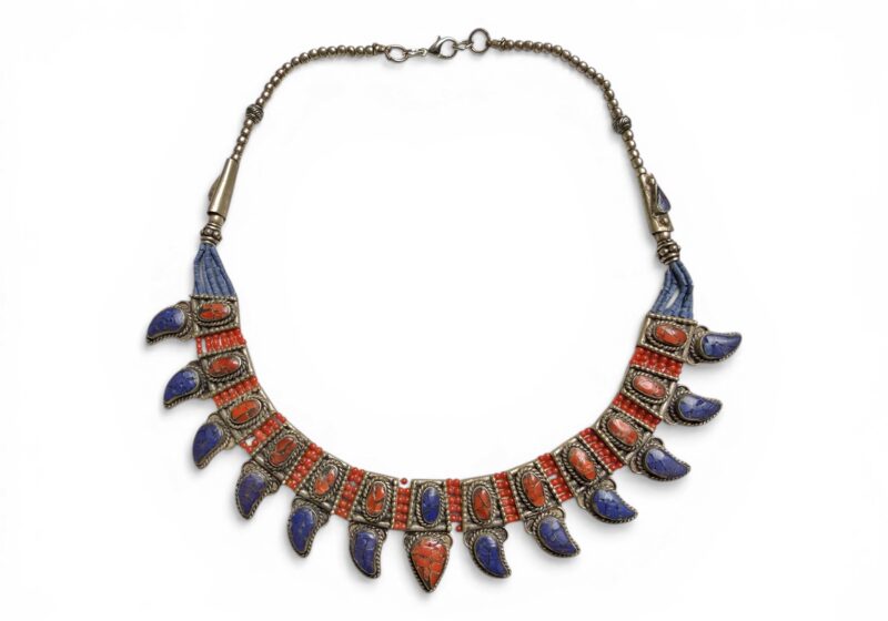 A Nepalese Silver Plated Curved Six Row Necklace Of Lapis And Coral Beads With Panels Of Coral Chips And Lapis Teardrops
