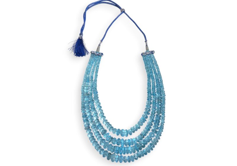 A Long Necklace With Four Graduated Strands Of Blue Topaz Small Facetted Button Beads.
