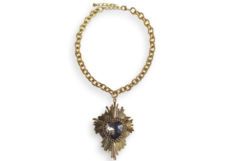 A Golden Metal Starburst Pendant With Domed Facetted Black Glass Heart Centre, On Golden Metal Chain Necklace.