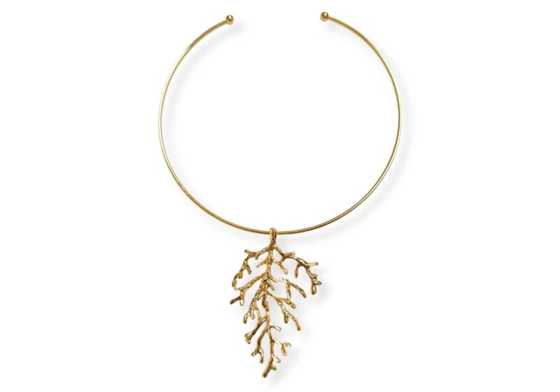 A Golden Metal Coral Branches Pendant On A Golden Metal Circular Band Torque Necklace.