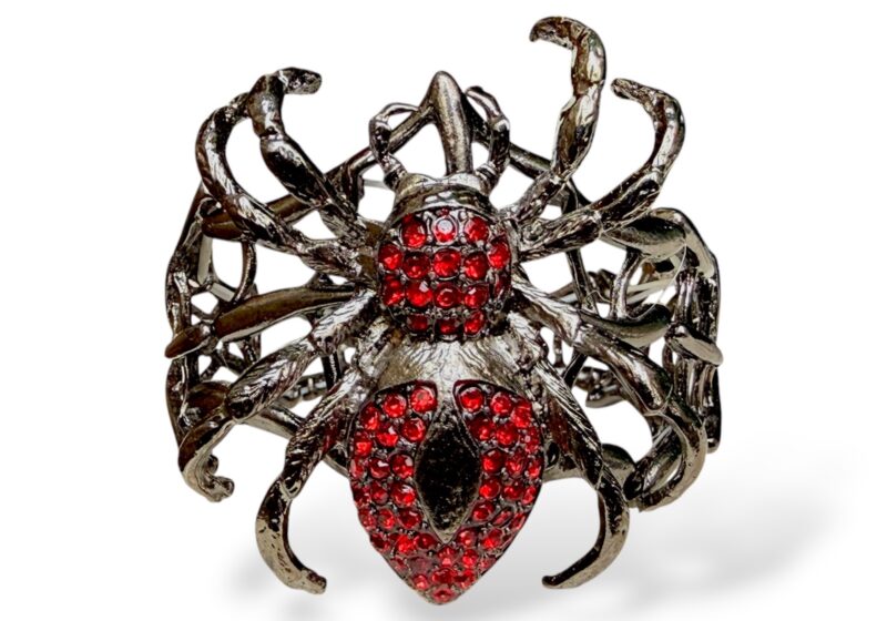 An Elasticated Bracelet Of Three Gunmetal Spiderweb Panels And A Large Spider Inlaid With Small Red Facetted Glass Beads.