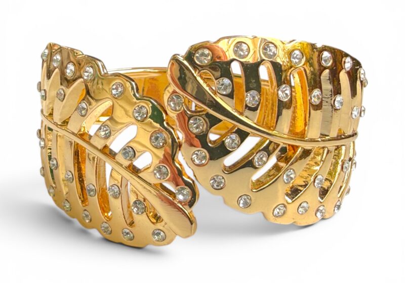 A Hinged Golden Metal Cuff Of Two Leaves Inlaid With Clear Facetted Glass Cabochons