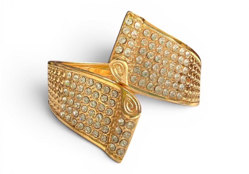 A Hinged Golden Metal Cuff Of Two Tapered Bands Inlaid With Clear Facetted Glass Cabochons