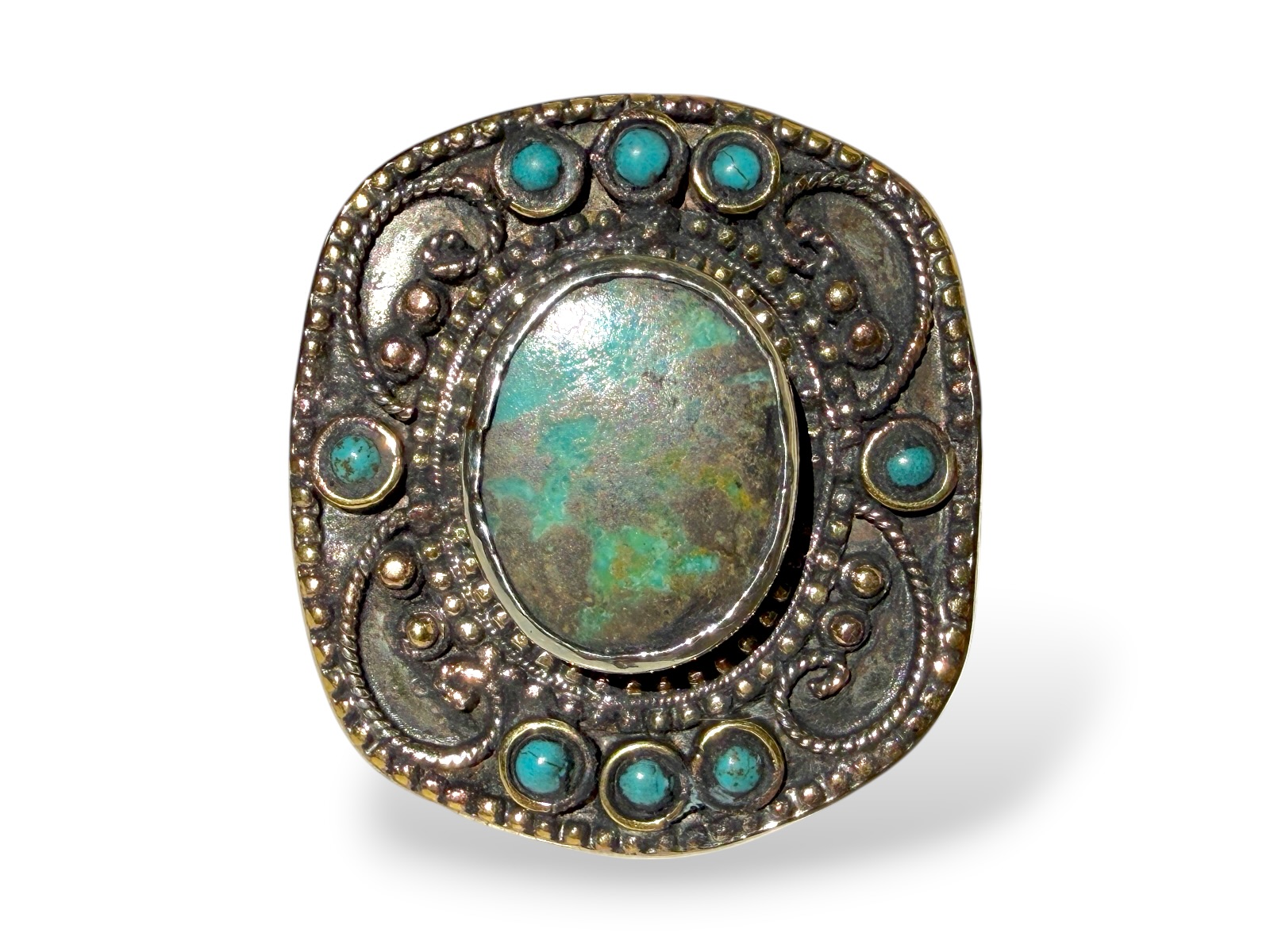 A Tibetan Silver And Golden Metal Large Rectangular Patterned Top Ring Inlaid With One Large And Eight Small Turquoise Cabochons.