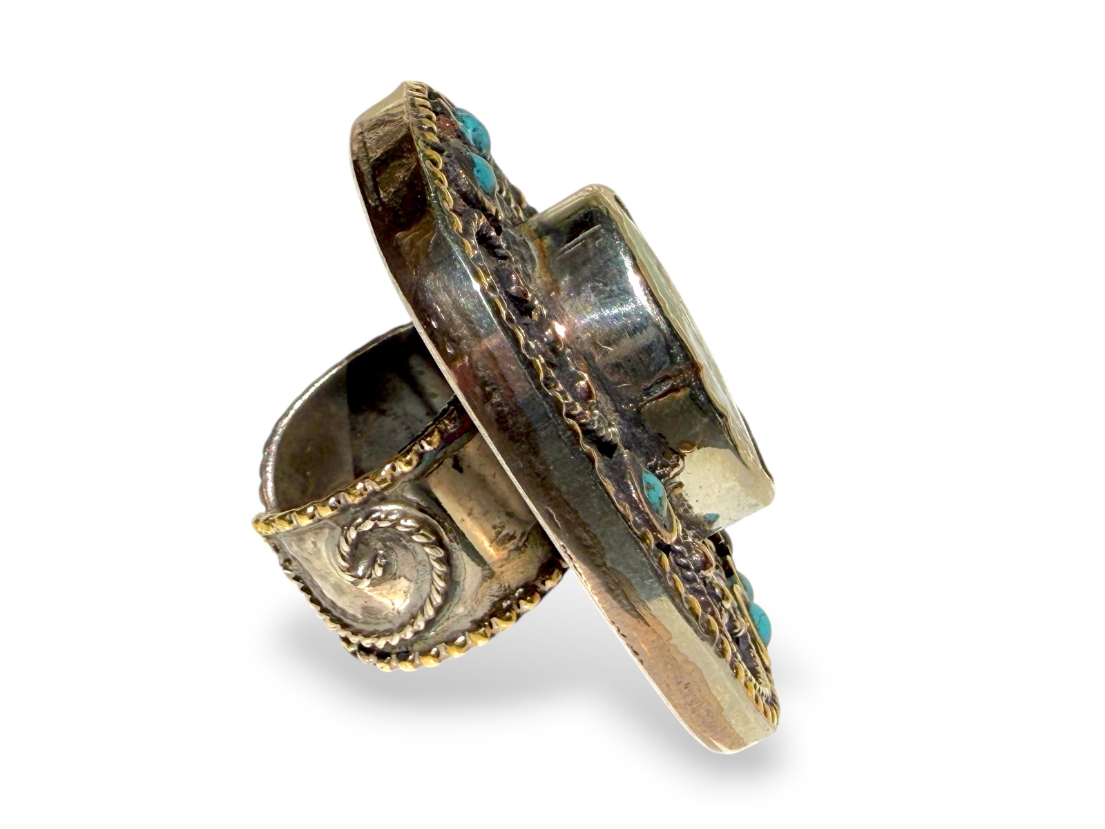 A Tibetan Silver And Golden Metal Large Rectangular Patterned Top Ring Inlaid With One Large And Eight Small Turquoise Cabochons. - Image 3