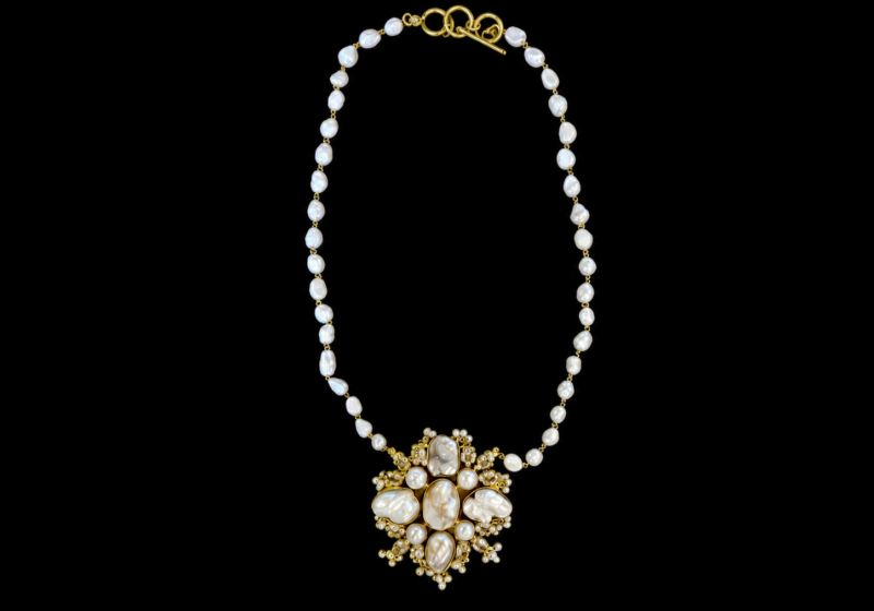 A Long Necklace Of Small White Freshwater Pearls, And A Golden Metal Pendant Inlaid With White Freshwater Pearls And Clear Facetted Glass Beads.