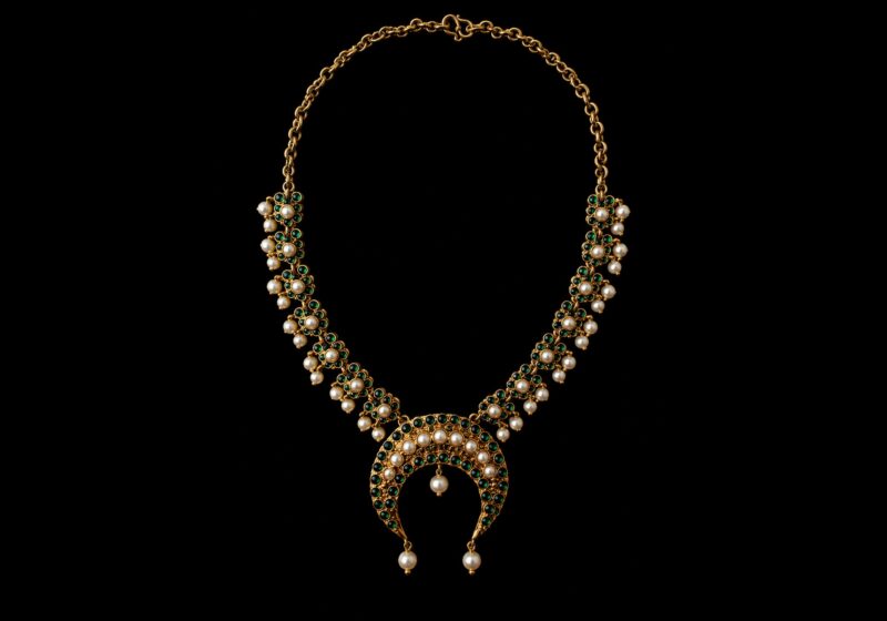 A Golden Metal Chain Necklace With Golden Metal Panels, And A Curved Pendant, Each Inlaid With Malachite Beads And White Freshwater Pearls.