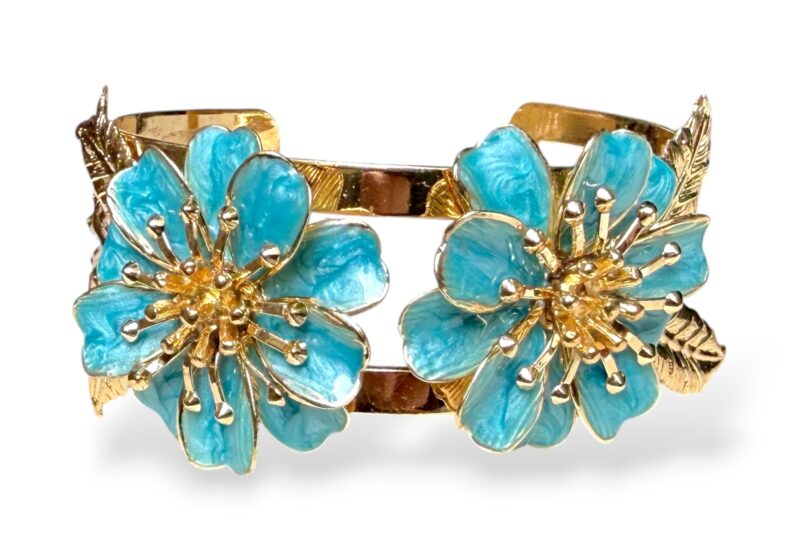 A Golden Metal Two Bands Open Cuff With Two Flowers Of Blue Enamelled Petals And Golden Metal Posts At The Centre.