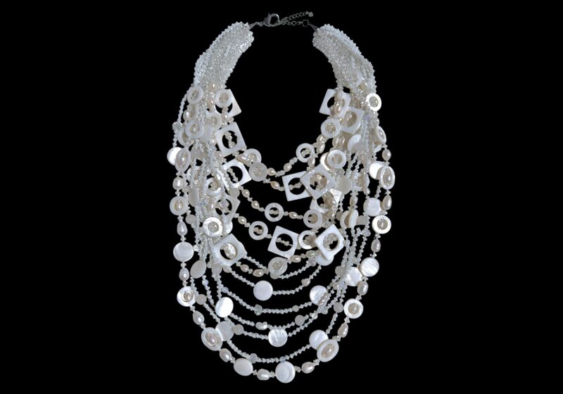 A Long Twelve Strand Necklace With M-O-P Shell Beads, White Freshwater Pearls, And White And Clear Facetted Glass Beads.