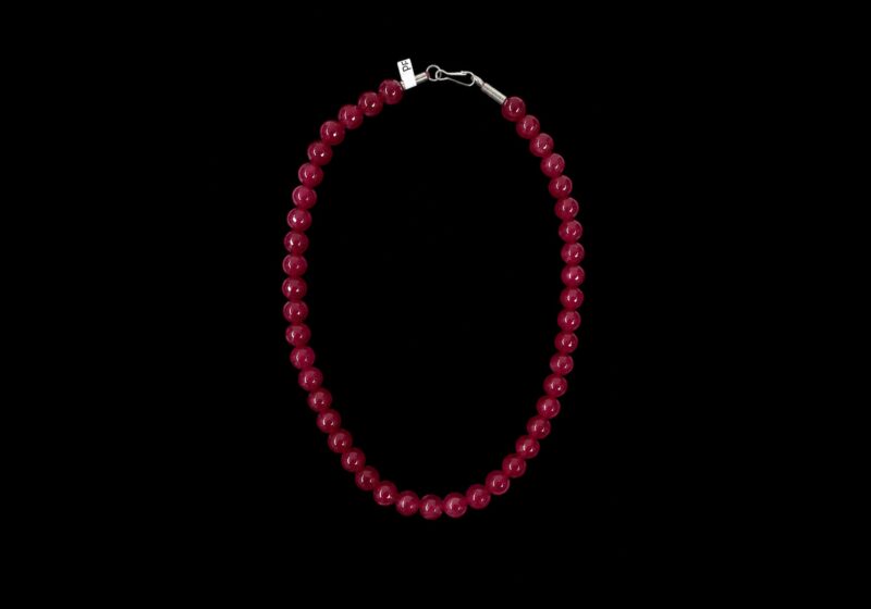 One Necklace Of Forty-Four Red Facetted Glass Round Beads.