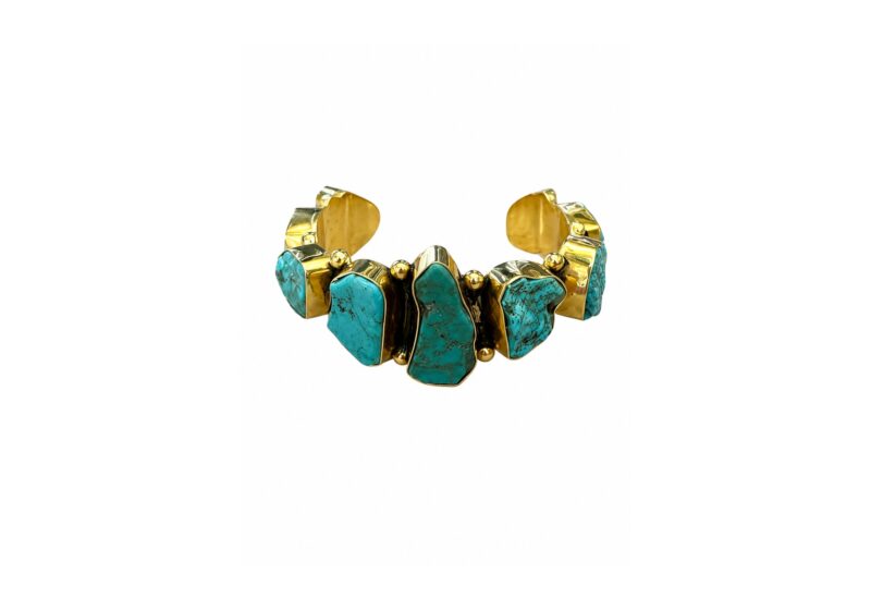 A Golden Metal Open Cuff With Nine Turquoise Irregular Shaped Nuggets, Each Set In A Raised Golden Metal Frame.