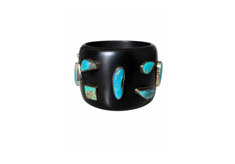 A Black Resin Wide Band Bangle With Turquoise Mixed Shaped And Sized Cabochons, Each Set In A Brass Case.
