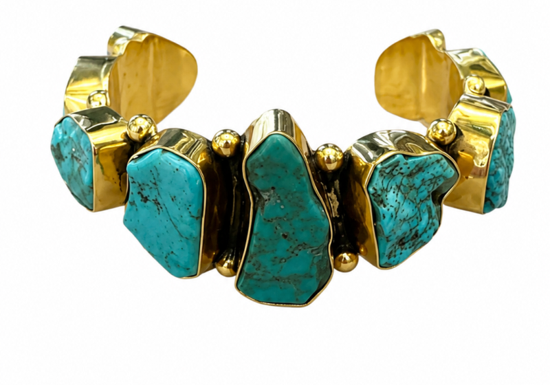 A Golden Metal Open Cuff With Nine Turquoise Irregular Shaped Nuggets, Each Set In A Raised Golden Metal Frame.