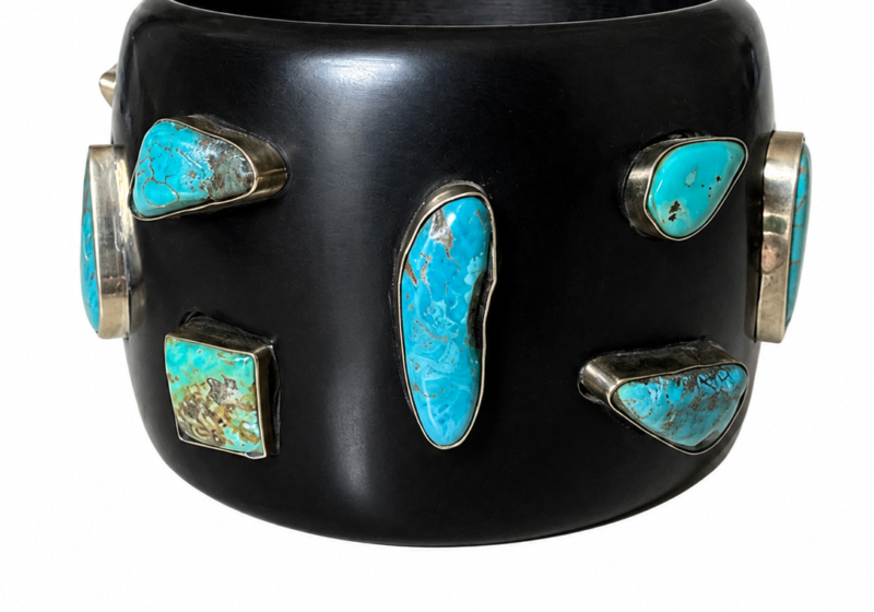 A Black Resin Wide Band Bangle With Turquoise Mixed Shaped And Sized Cabochons, Each Set In A Brass Case.