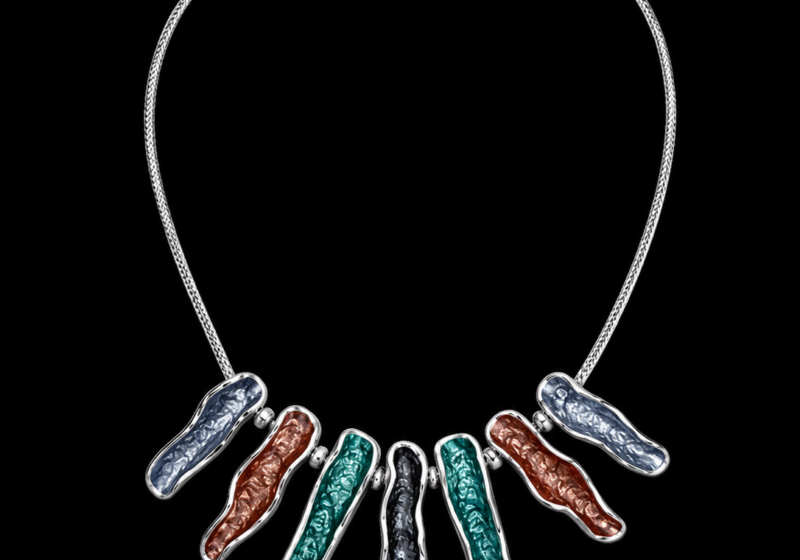 A Silvered Metal Chain Necklace With Seven Graduated Length, Enamel Painted Patterned Pendants, In Four Different Colours.