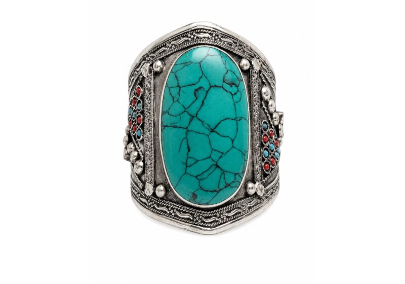 An Afghan Silvered Metal Open Cuff, Inlaid With A Turquoise Dyed Howlite Domed Oval Panel And Small Round Blue And Red Glass Beads.