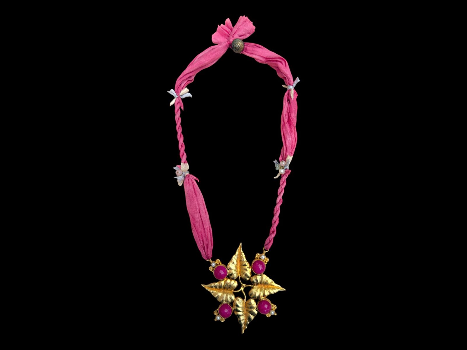 A long Necklace Of Two Pink Silk Strands, With A Gold Plated Four Leaves Pendant, Inlaid With Pink Dyed Domed Circular Facetted Agates, And Small Round White Freshwater Pearls.