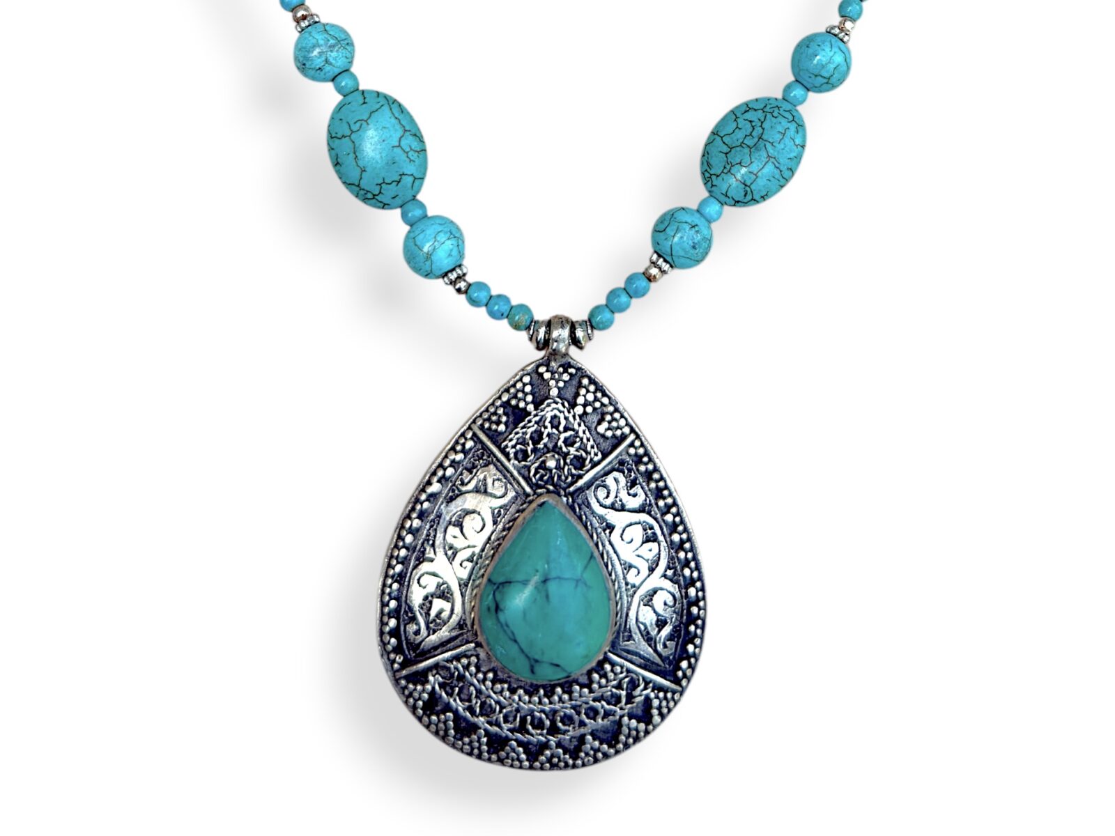 A Long Nepalese Necklace Of Turquoise Dyed Howlite Small Round Beads, With A Nepalese Silver Plated Patterned Teardrop Pendant Inlaid With A Turquoise Domed Teardrop Shaped Cabochon. - Image 2