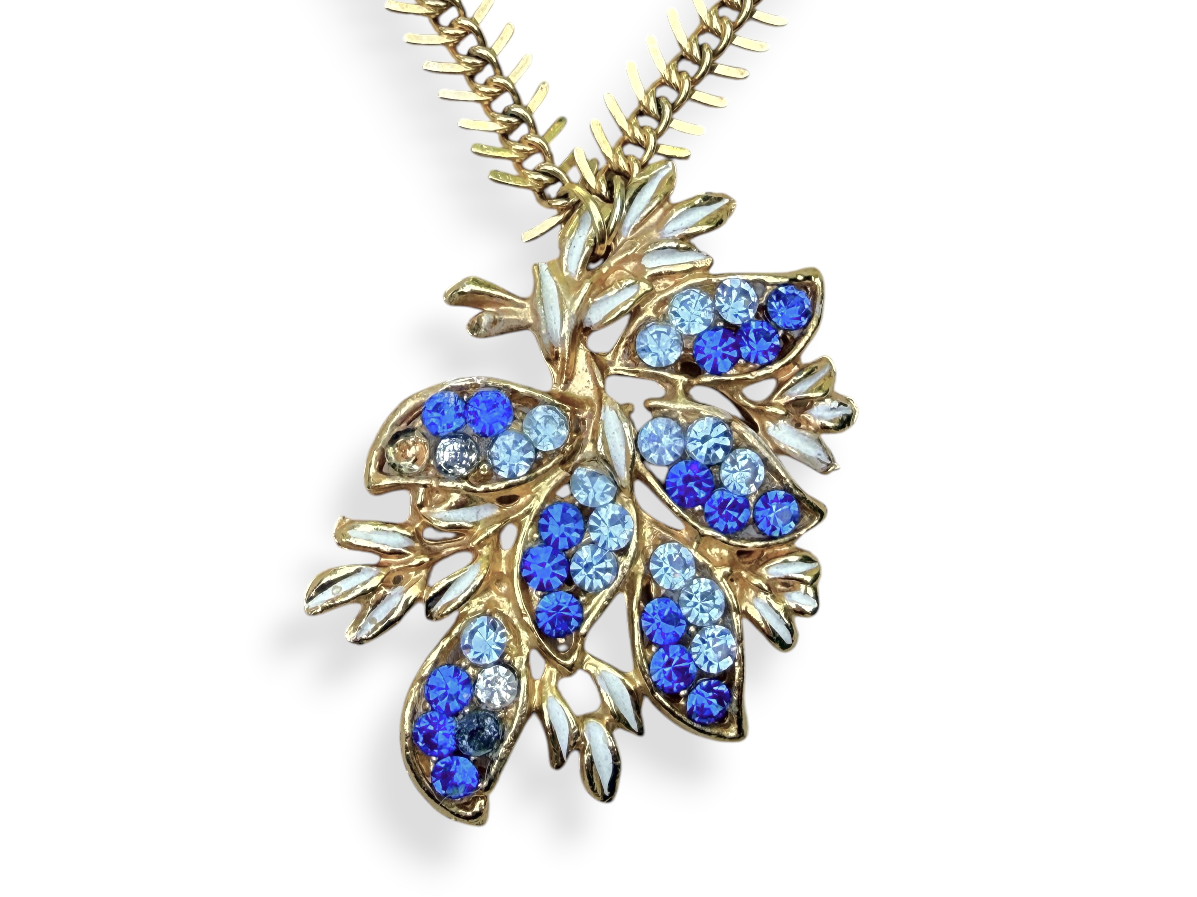 A Golden Metal Long Fishbone Chain Necklace With A Golden Metal Floral Pendant Inlaid With Small Light And Dark Blue Facetted Glass Cabochons. - Image 2