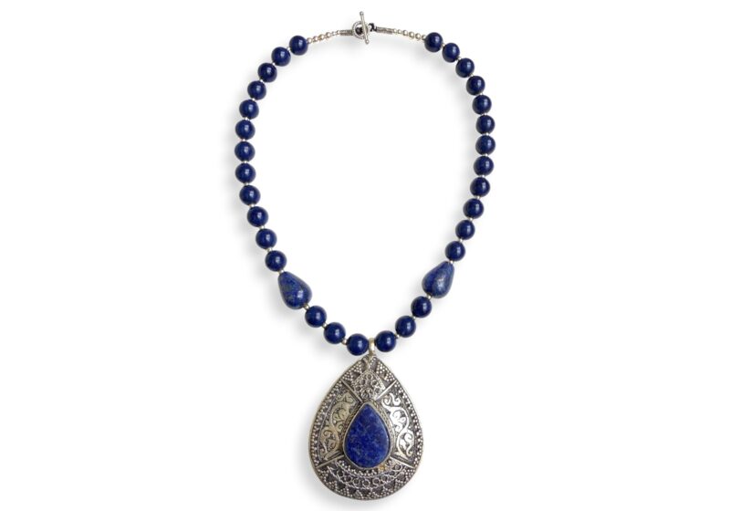 An Afghan Necklace Of Lapis Lazuli Round Beads And Small Silver Plated Round Spacers, Lapis Beaded Necklace With An Afghan Silver Plated Patterned Teardrop Shaped Pendant With A Lapis Lazuli Teardrop Shaped Cabochon.