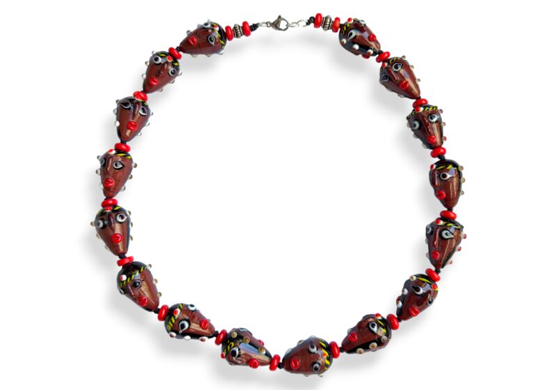 A Knotted Necklace Of Sixteen Javanese Glass Two Faces Beads With Red Glass Circular Spacers. Indonesia.