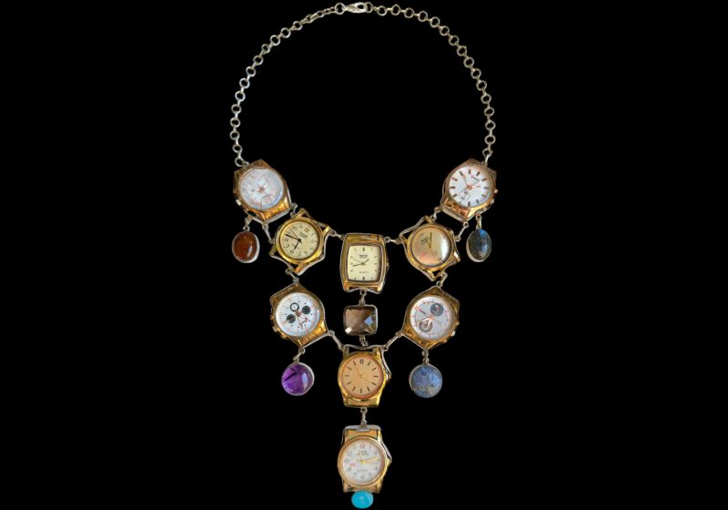 A Long Silvered Metal Chains Necklace With Nine Vintage Watch Faces And Six Semi-Precious Cabochon Pendants.