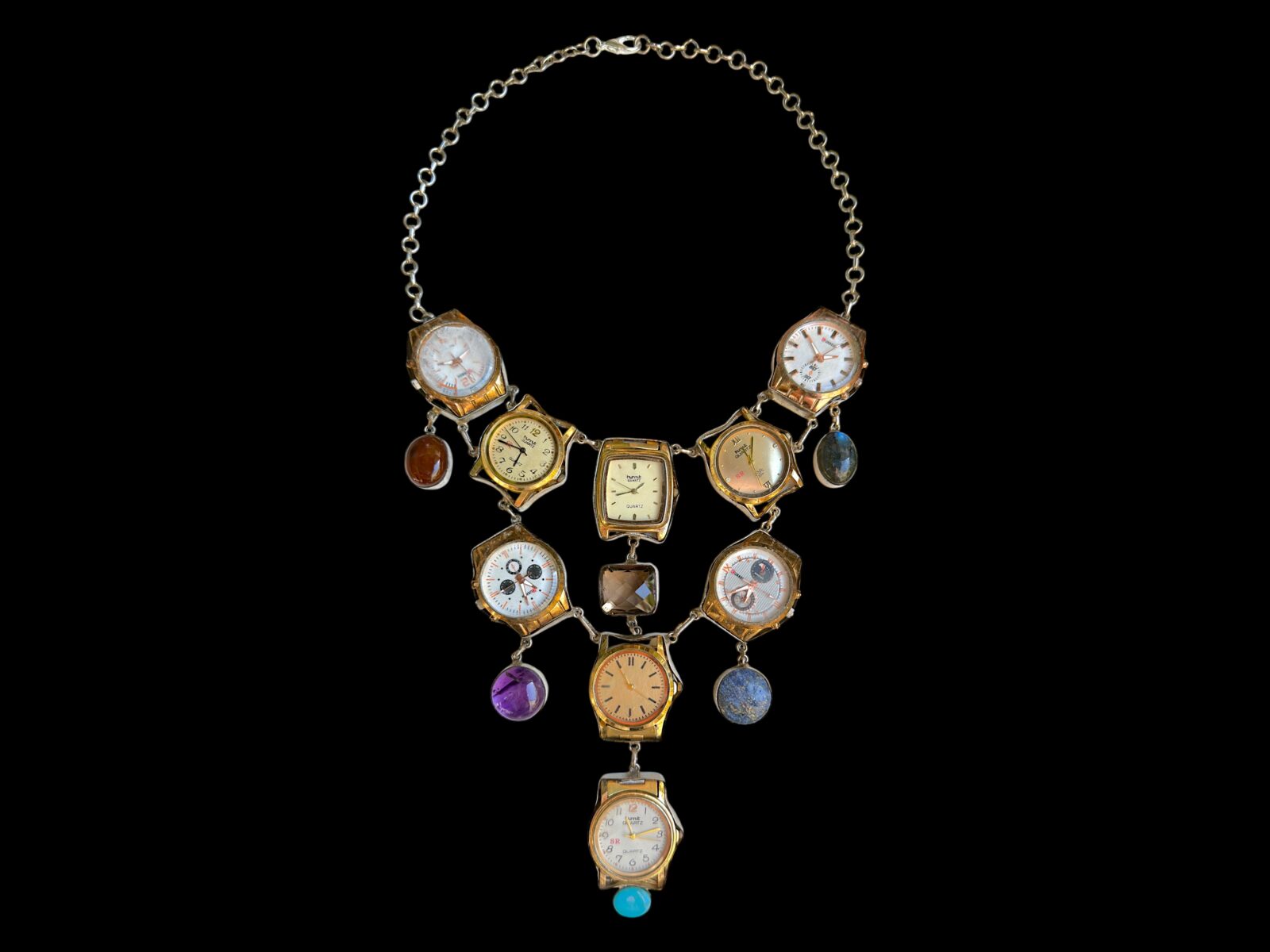 A Long Silvered Metal Chains Necklace With Nine Vintage Watch Faces And Six Semi-Precious Cabochon Pendants.