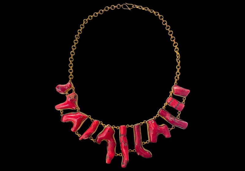 A Golden Metal Chain Necklace With Linked Red Dyed Sea Bamboo Coral Irregular Shaped Branches, Each Set In A Golden Metal Frame.