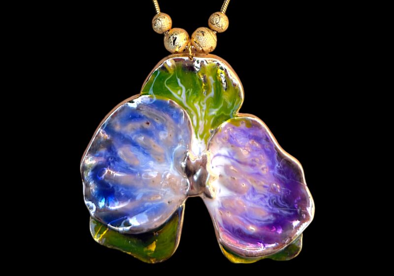 A Golden Metal Enamel Painted Orchid Flower Pendant/Brooch On Long Golden Metal Snake Chain Necklace With Four Textured Golden Metal Round Beads.