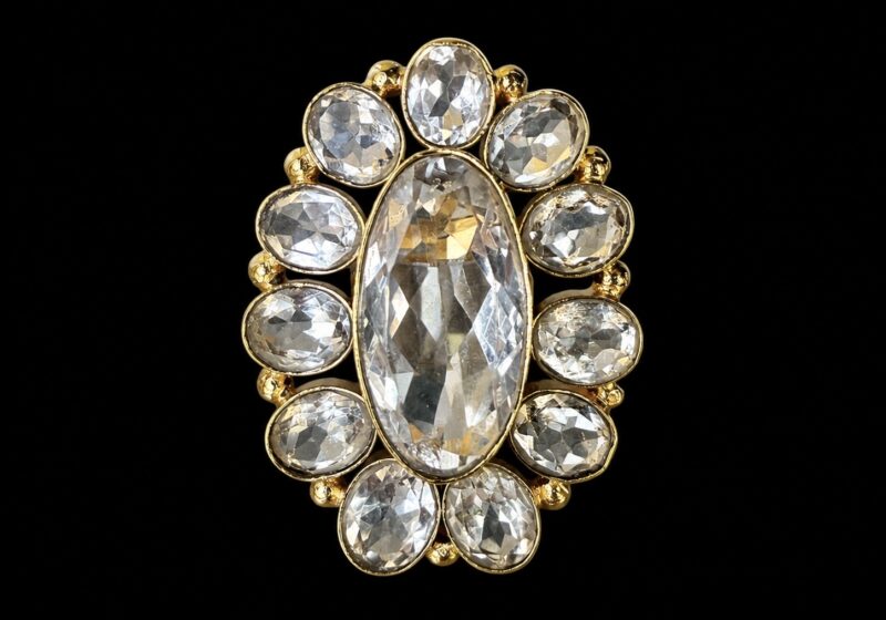 A Large Gold Plated Oval Flower Shaped Ring With Twelve Facetted Rock Crystal Oval Cabochons, Each Set In A Gold Plated Frame.